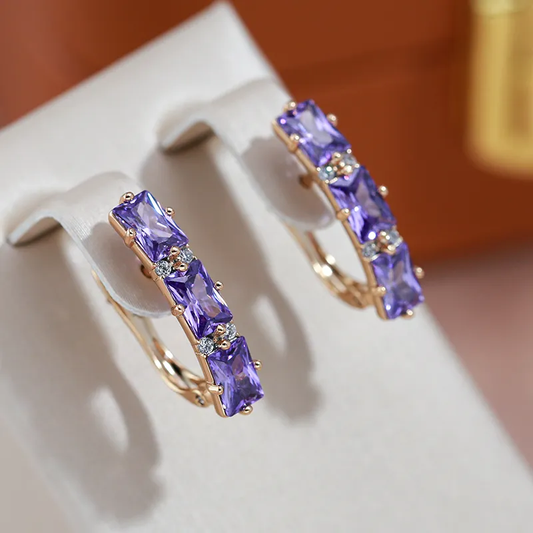 Exquisite golden earrings with sparkling violet crystals