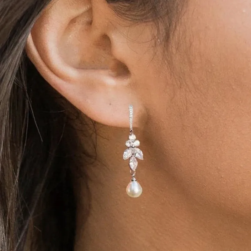 Elegant earrings with shimmering pearls and sparkling zirconia leaves