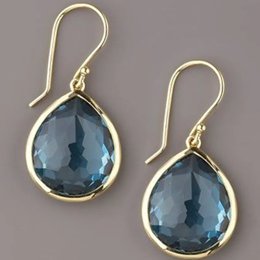 Glamorous gold earrings with sparkling blue crystal drops