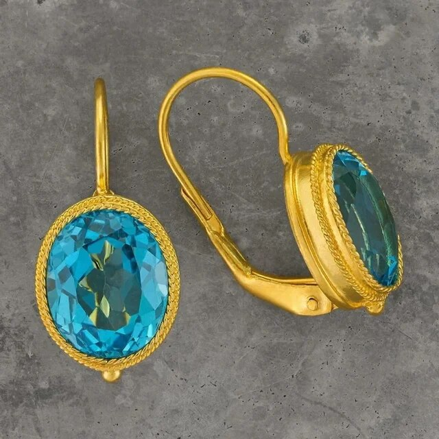 Elegant vintage earrings with radiant blue crystals in a noble gold frame