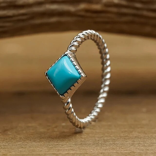 Vintage silver ring with turquoise braided design