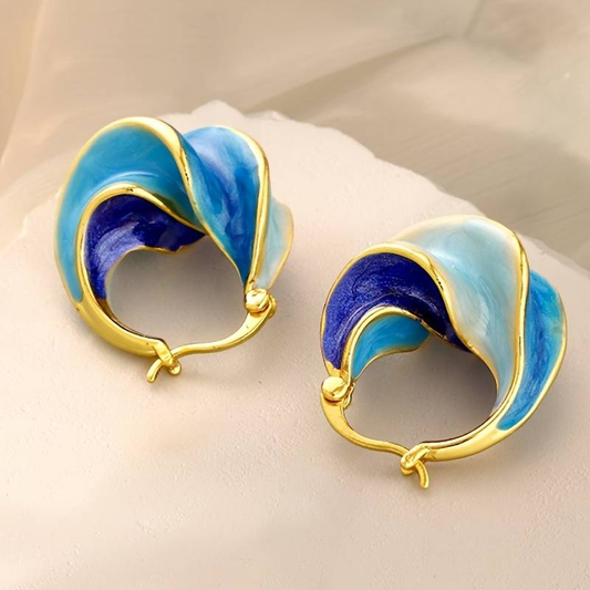 Elegant vintage earrings made of shimmering blue enamel with golden accents