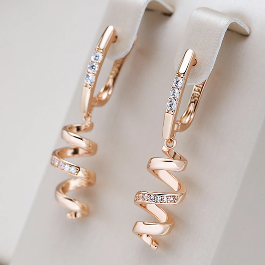 Stylish gold spiral earrings with sparkling zirconia stones