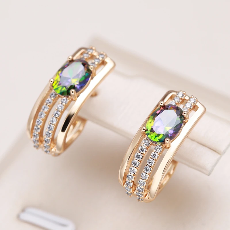 Stylish gold earrings with sparkling zirconia and luxurious green crystal