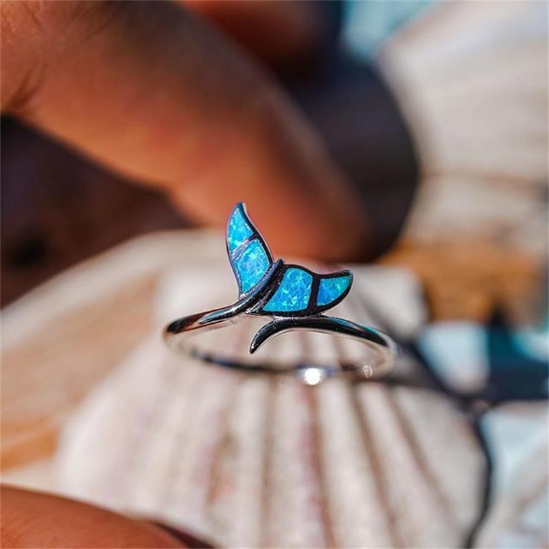 Fascinating silver ring with whale tail design and sparkling opal